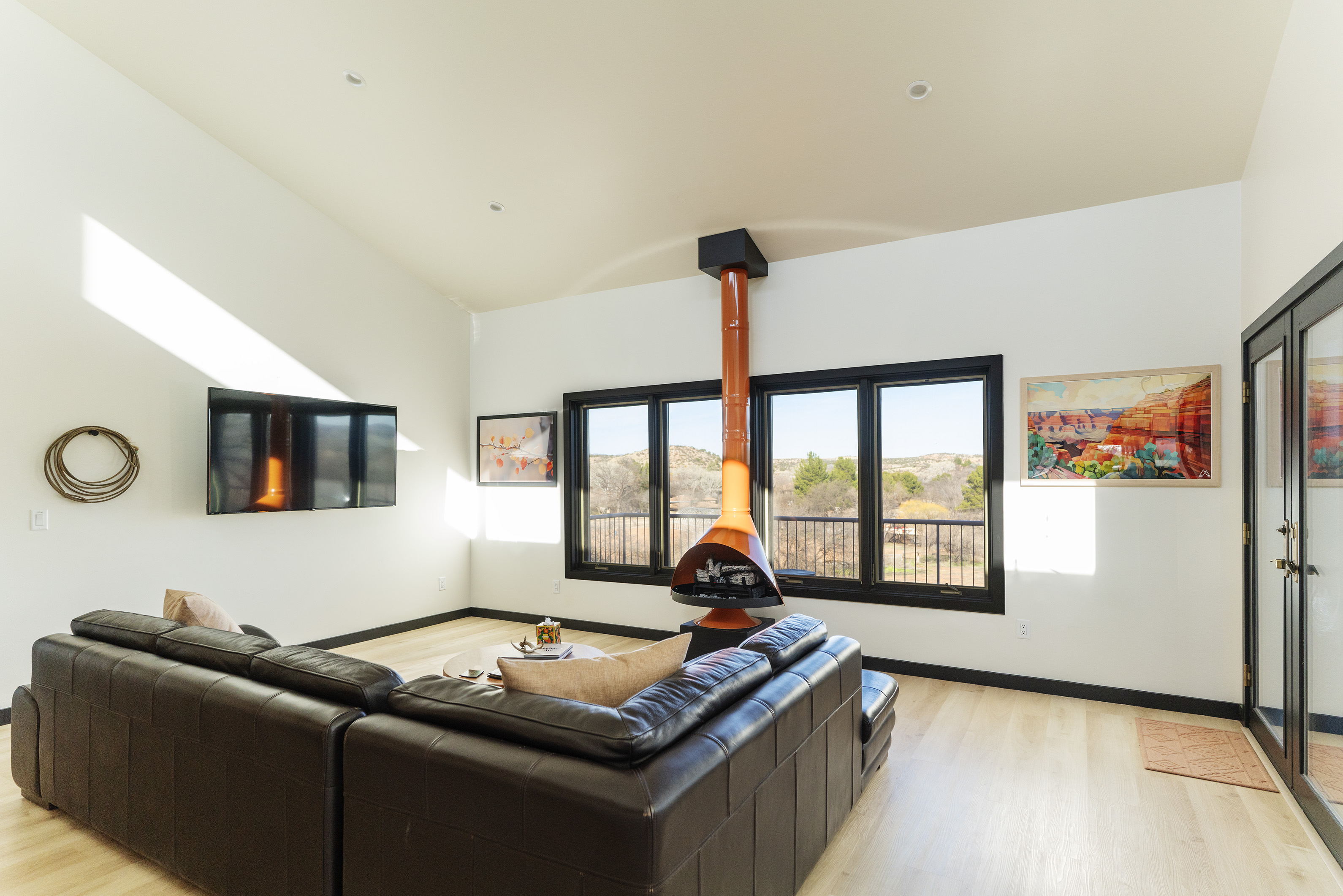 Tu'nlii House — vaulted living room with mid-century fireplace and panoramic views